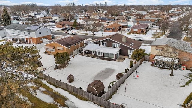 snowy aerial view featuring a residential view