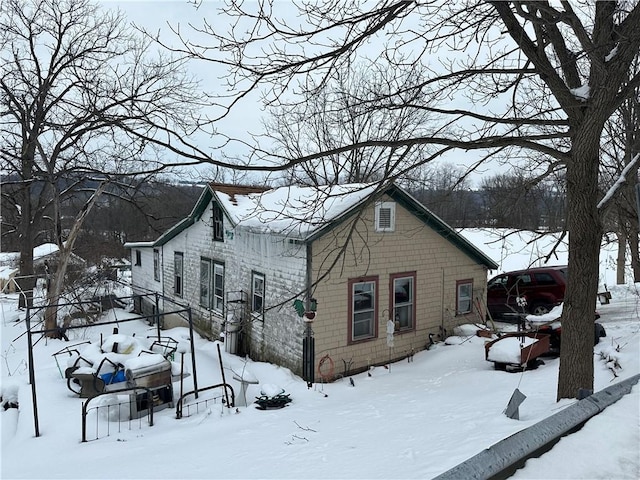 view of snowy exterior featuring a garage