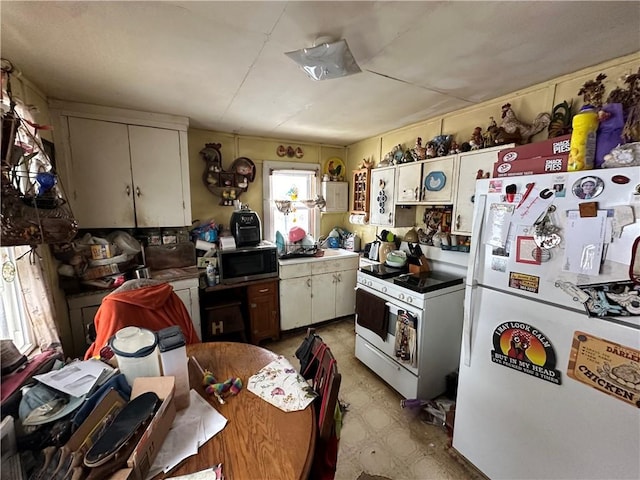 kitchen with light floors and white appliances