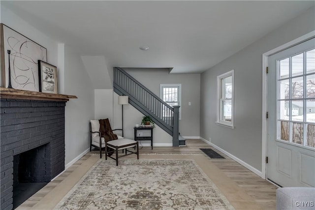 entryway featuring visible vents, a fireplace, baseboards, and stairs