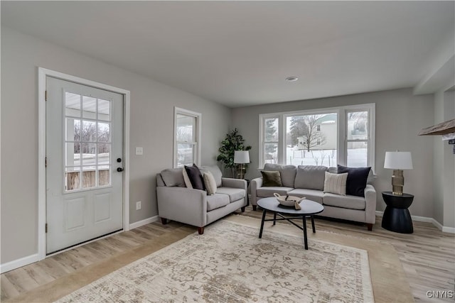 living area with wood finished floors and baseboards