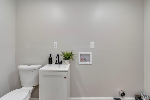 bathroom featuring toilet and vanity