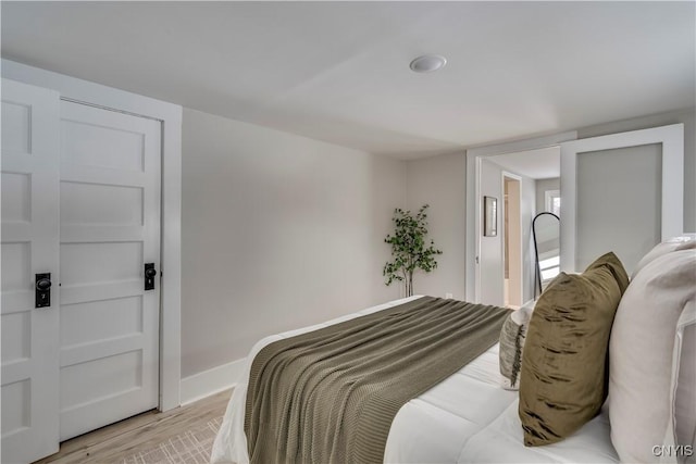 bedroom with baseboards and light wood-style floors