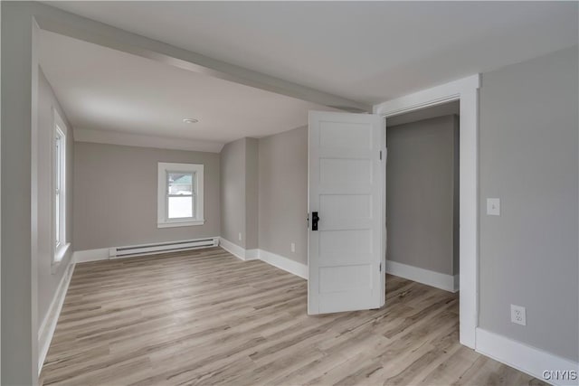 unfurnished room with light wood-type flooring, a baseboard radiator, and baseboards