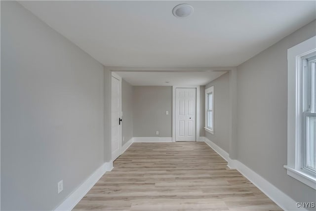 spare room with light wood finished floors and baseboards