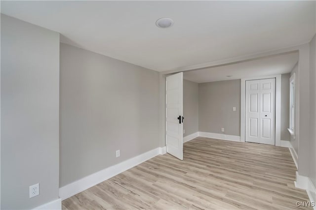 unfurnished room with light wood-style floors and baseboards