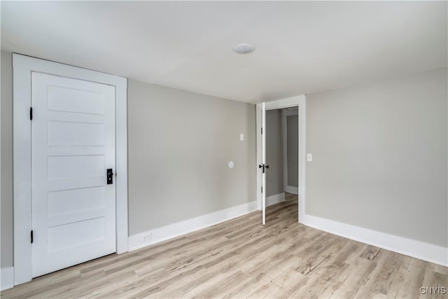 unfurnished room featuring light wood-style flooring and baseboards