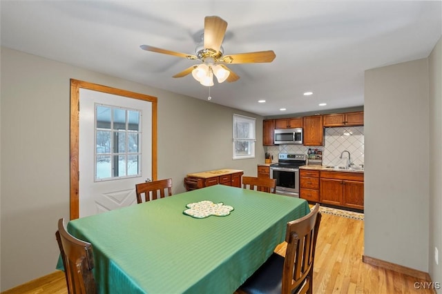 dining space with light wood finished floors, recessed lighting, a ceiling fan, and a healthy amount of sunlight