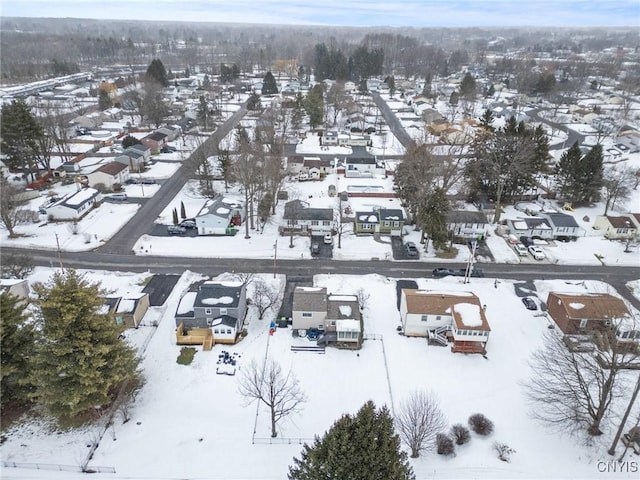 snowy aerial view with a residential view