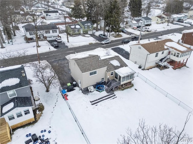 snowy aerial view featuring a residential view