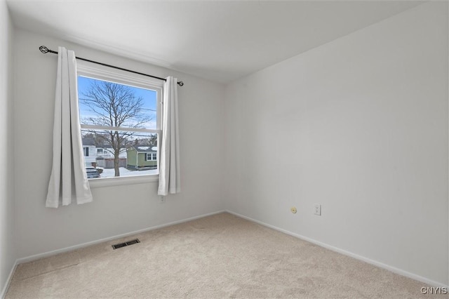 carpeted spare room with baseboards and visible vents