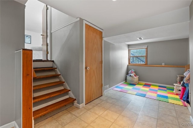 stairs featuring visible vents and baseboards