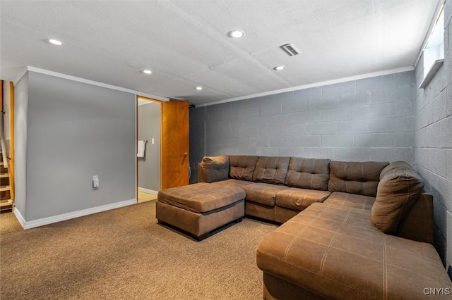 living room with concrete block wall, carpet, recessed lighting, visible vents, and baseboards