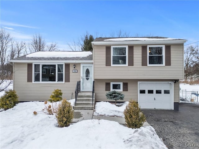 tri-level home with entry steps and a garage