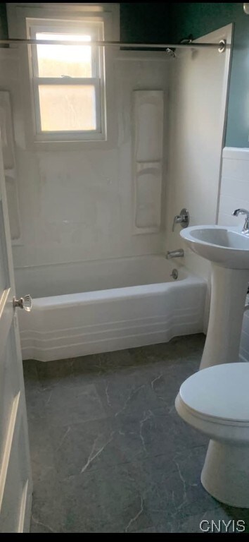 bathroom featuring toilet and bathing tub / shower combination