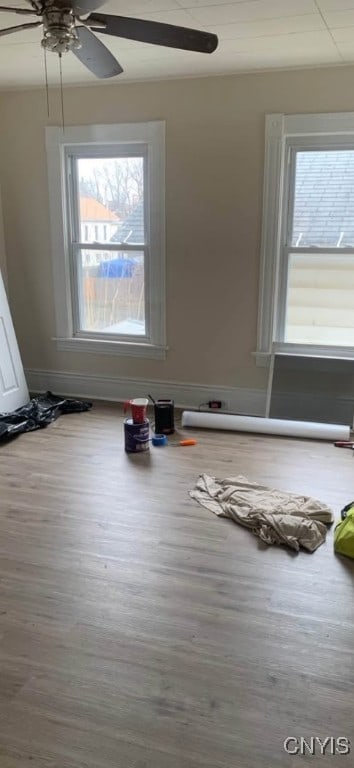 empty room featuring a ceiling fan and wood finished floors