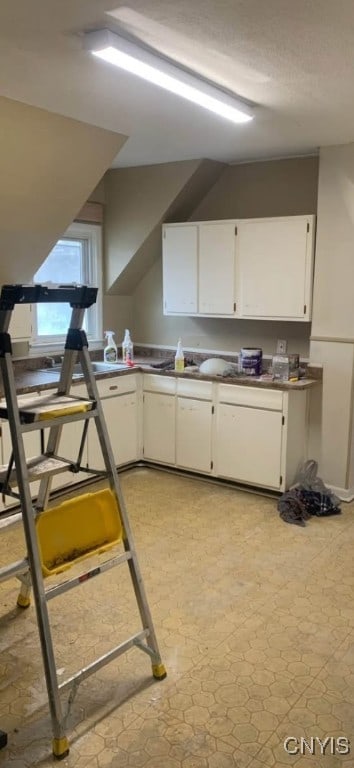 kitchen featuring white cabinets and light floors