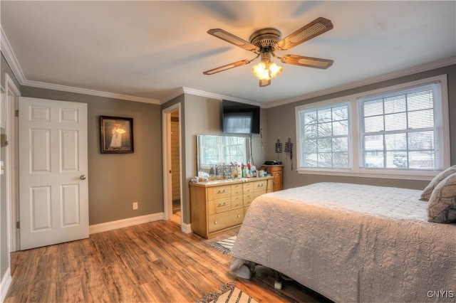 bedroom with a ceiling fan, crown molding, baseboards, and wood finished floors