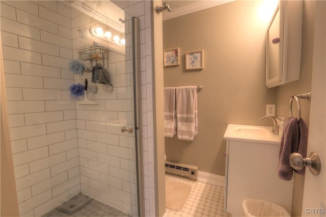 full bath with a baseboard heating unit, vanity, baseboards, ornamental molding, and a stall shower