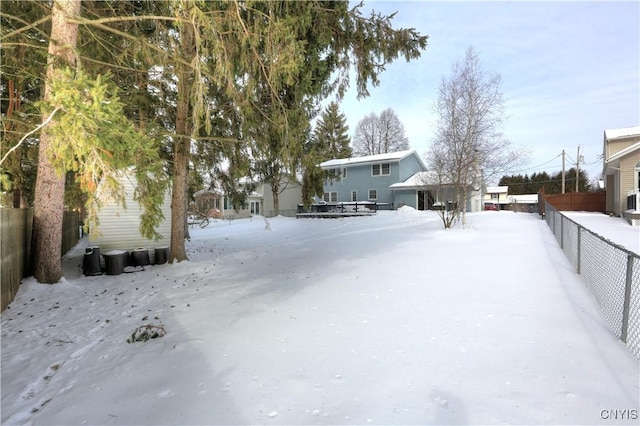 snowy yard with fence