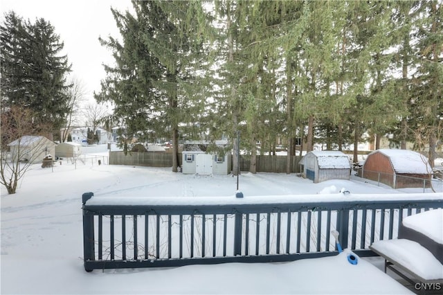 exterior space featuring a fenced backyard, a storage unit, and an outbuilding