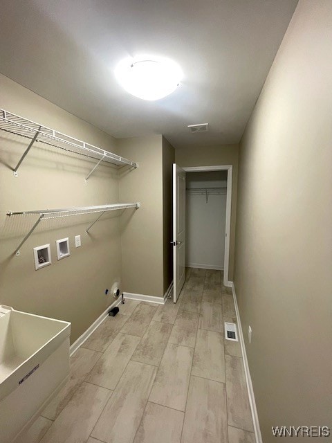 washroom with gas dryer hookup, washer hookup, laundry area, visible vents, and light wood-type flooring