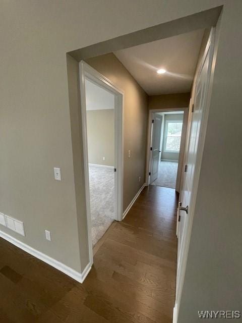 corridor featuring baseboards, recessed lighting, wood finished floors, and visible vents