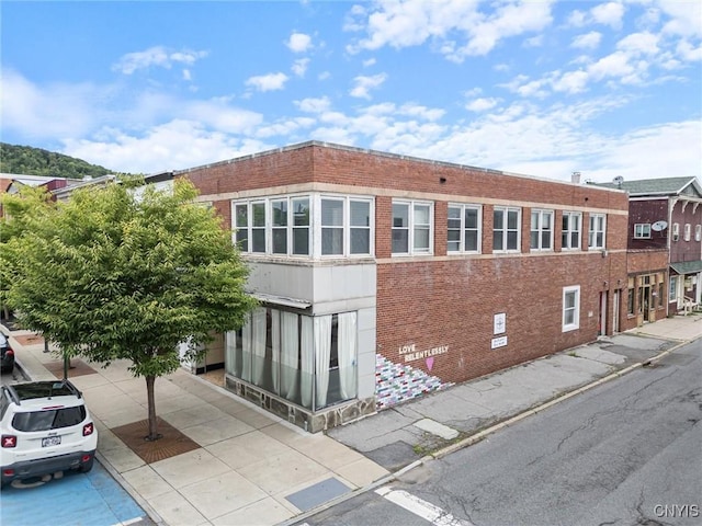 view of side of property featuring brick siding