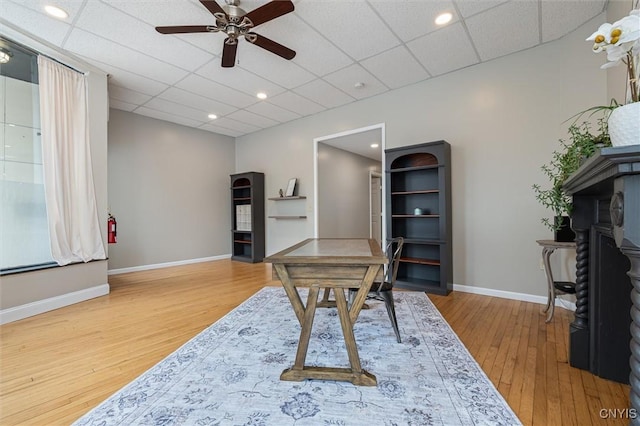 79-81 Main St, Sidney, NY 13838 - home office featuring a ceiling fan, a paneled ceiling, baseboards, and wood finished floors