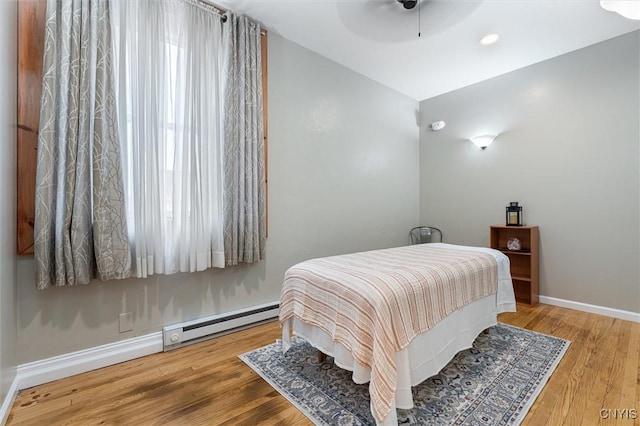 79-81 Main St, Sidney, NY 13838 - bedroom with baseboards, ceiling fan, baseboard heating, and wood finished floors