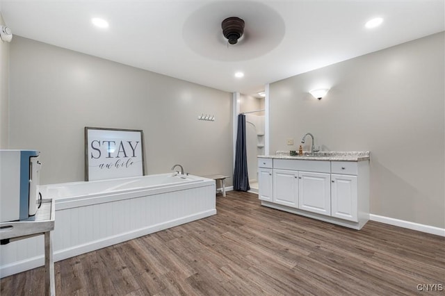 79-81 Main St, Sidney, NY 13838 - bar featuring recessed lighting, wood finished floors, a sink, a ceiling fan, and baseboards