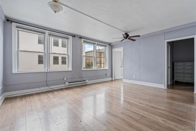 79-81 Main St, Sidney, NY 13838 - unfurnished room with baseboard heating, wood finished floors, a ceiling fan, and baseboards