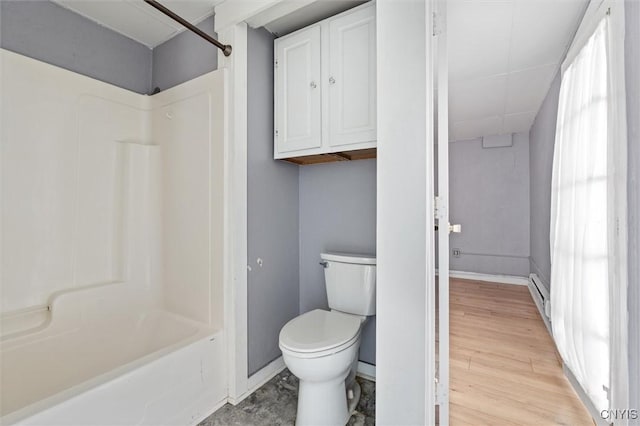 79-81 Main St, Sidney, NY 13838 - bathroom with baseboards, toilet, shower / tub combination, wood finished floors, and baseboard heating