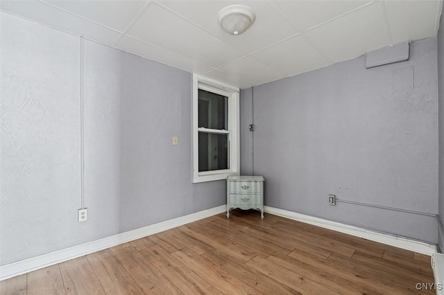 79-81 Main St, Sidney, NY 13838 - spare room featuring a paneled ceiling, wood-type flooring, and baseboards