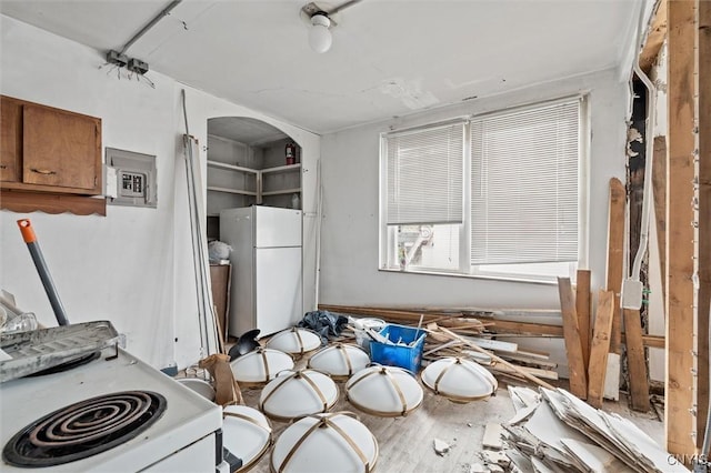 79-81 Main St, Sidney, NY 13838 - kitchen with white appliances, brown cabinetry, and electric panel