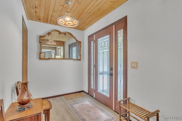 entrance foyer with light wood-style floors, wood ceiling, and plenty of natural light