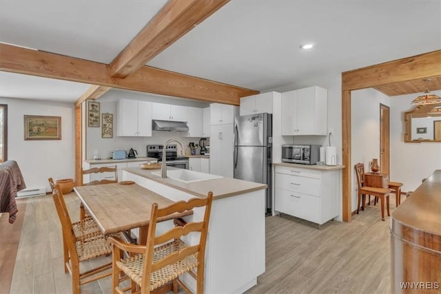 kitchen featuring light countertops, appliances with stainless steel finishes, beamed ceiling, and under cabinet range hood