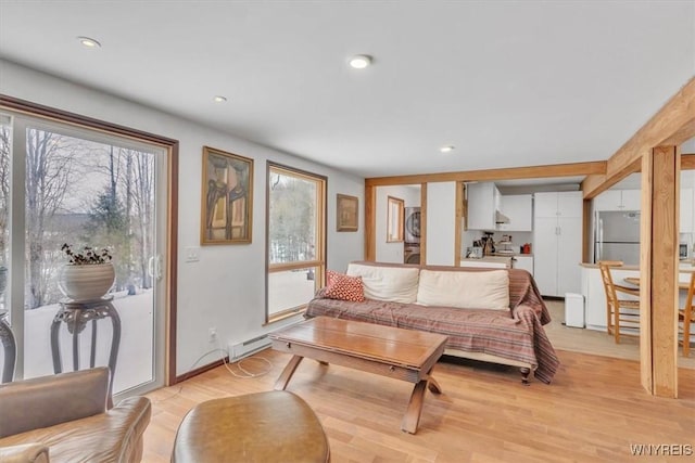 living area with light wood-style flooring and recessed lighting