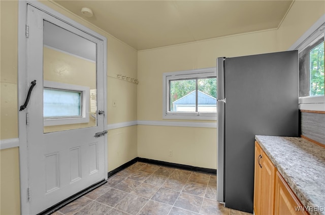 doorway to outside with a healthy amount of sunlight and baseboards