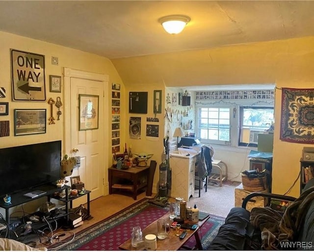 interior space with carpet and vaulted ceiling