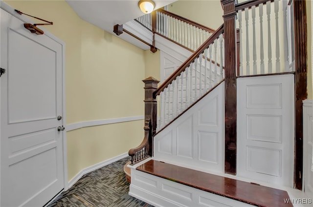 interior space featuring stairs and baseboards