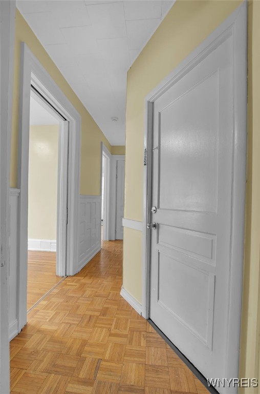 hallway featuring a wainscoted wall