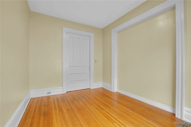 unfurnished room featuring light wood-style floors and baseboards