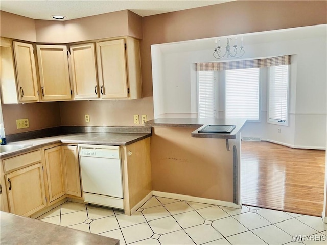 kitchen featuring white dishwasher, a notable chandelier, a peninsula, visible vents, and light brown cabinetry