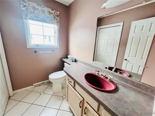 bathroom featuring tile patterned flooring, toilet, visible vents, vanity, and baseboards