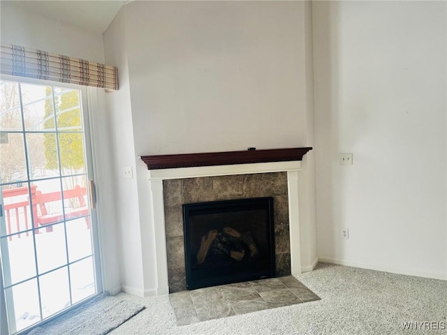 interior details with a fireplace, carpet flooring, and baseboards