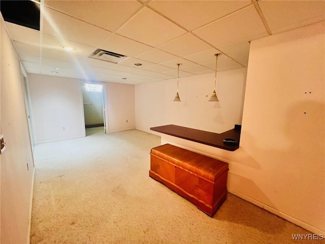 interior space featuring a drop ceiling, visible vents, and baseboards