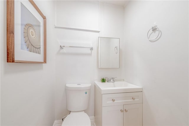 half bath with vanity and toilet