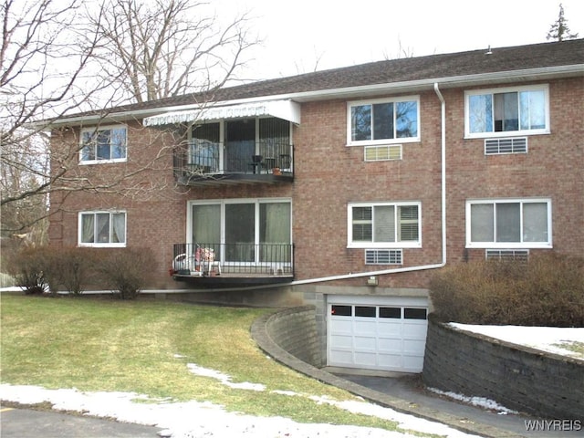 view of front of property with a garage, brick siding, and a front lawn