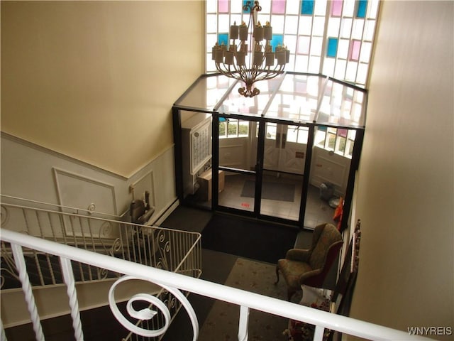 31 Park Lane Ct, Amherst, NY 14221 - interior space featuring a wainscoted wall, a decorative wall, and a notable chandelier